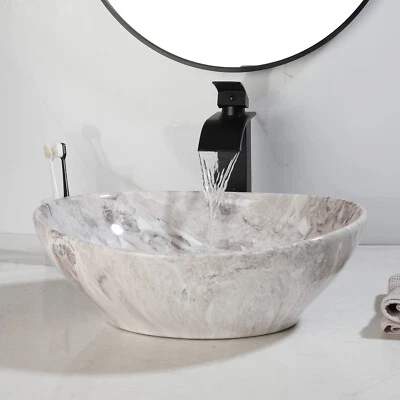 Fregadero de mármol ovalado para baño lavabo de cerámica con grifo negro y desagüe Foto 1 de 4