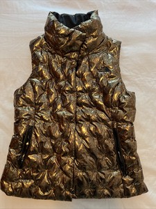 black and gold north face vest
