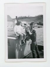 Playful moment - Man lifting woman unto roof   vintage snapshot found photo 