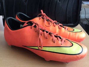 white and orange nike boots