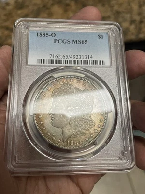 Toned 1885-O Morgan Dollar PCGS MS65 GEM - Image 1 of 2