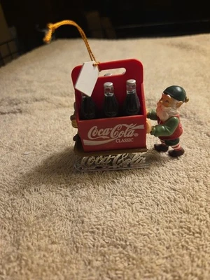 Coca Cola Ornament ELF WITH SIX PACK OF COKE BOTTLES ON SLED - Image 1 of 4