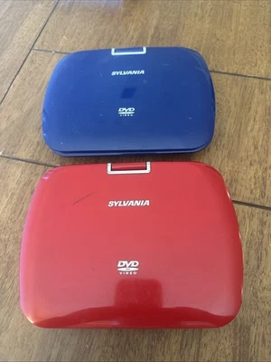 Pair Of Sylvania DVD Players Red And Blue No Chords Working? Seem Clean - Image 1 of 4