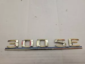 Mercedes OEM 1985-1992 300 SE 300SE New NOS Gold Rear Trunk Emblem Badge Logo - Bild 1 von 2