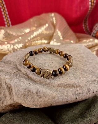 Cuentas de ojo de tigre de 6,5 pulgadas, con pulsera de plástico con dije de elefante, cordón elástico transparente Foto 1 de 2