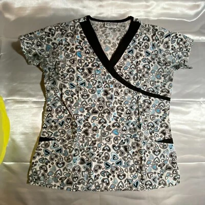 Blusa Médica UA (Uniform Advantage), Talla S, Corazones Negros/Azules sobre Blanco, Ribete Negro Foto 1 de 3