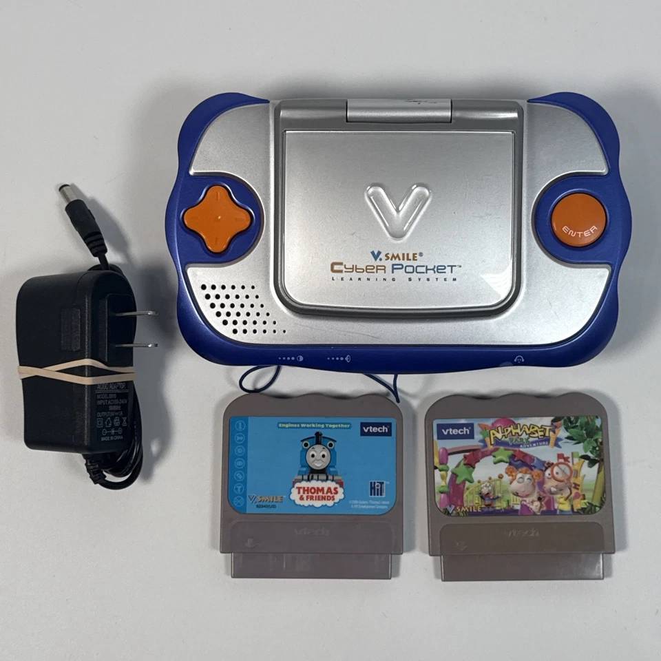 Sistema de aprendizaje VSmile Vtech Cyber Pocket probado incluye 2 juegos y adaptador de CA Foto 1 de 4
