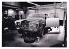 ROLLS ROYCE ON AXEL STANDS IN WORKSHOP PHOTOGRAPH.