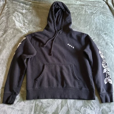 Sudadera con capucha negra con flores blancas en la manga talla pequeña Obey Foto 1 de 3