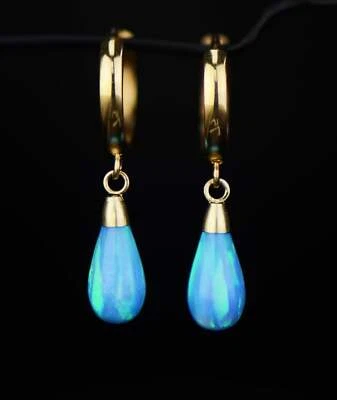 Pendientes de aro Huggie colgantes de ópalo de oro amarillo de 14k Foto 1 de 2