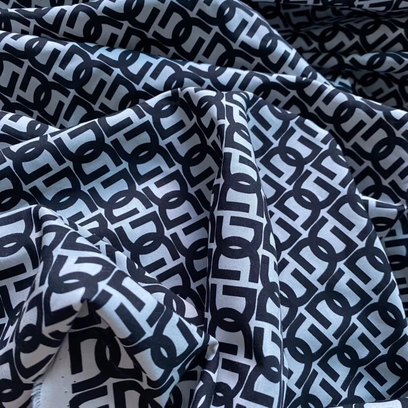 Tela mezcla Deadstock DG por yarda 55 % seda morera 45 % algodón logotipo Foto 1 de 4