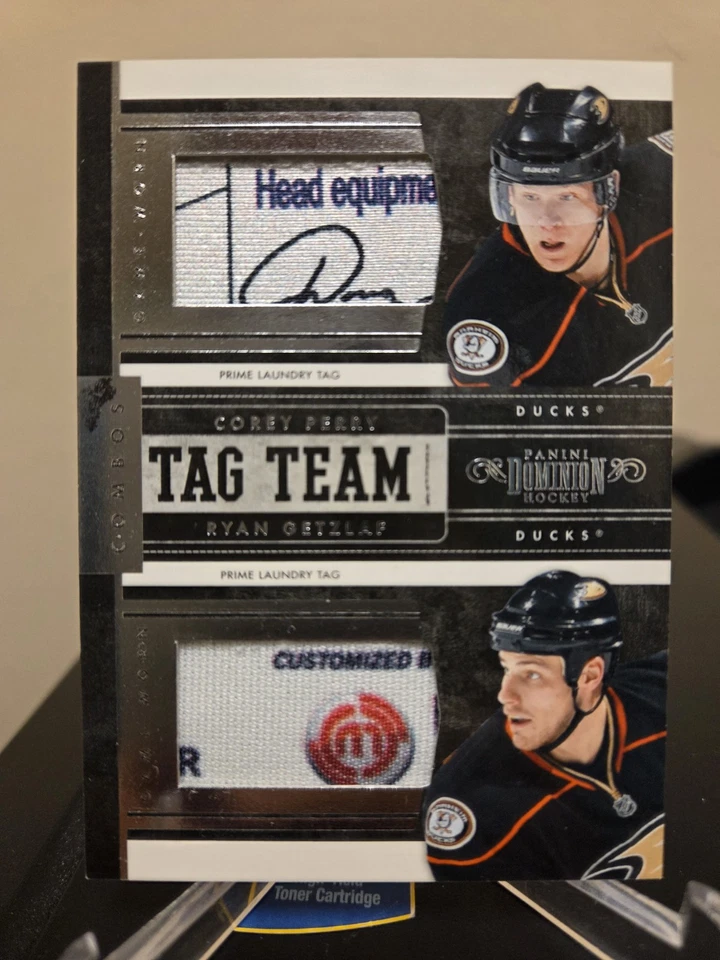 Corey Perry Ryan Getzlaf 2011 Panini Dominion Ducks Tag Team Dual Game Used Tags - Image 1 of 2