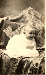 Vintage RPPC Postcard of a Baby on a blanket with Horses c1910 - Picture 1 of 3