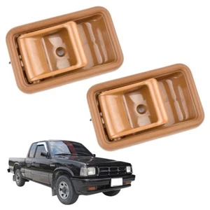 Par de soportes de manija de puerta interior marrón para camioneta Mazda B2500 323 1985-1998 - Imagen 1 de 6