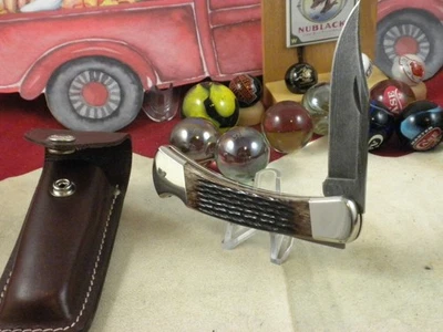 CUCHILLO CAZADOR PLEGABLE BUCK 110 EE. UU. COMO NUEVO EN FUNDA ORIGINAL HUESO MARRÓN DAMASCO Foto 1 de 4