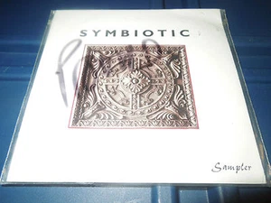 SYMBIOTIC - SAMPLER CD COMPILATION- 1996 PROMO VERY RARE - BRAND NEW - 11 TRACKS - Picture 1 of 1
