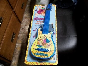 Hanna Barbera The Flintstone's Toy Rock Guitar New Sealed 1993 blue & yellow - Picture 1 of 3