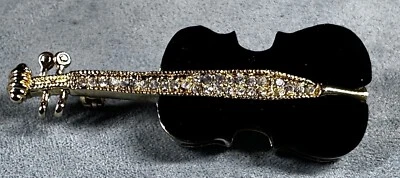Broche prendedor de violín de acrílico y cristal negro tono dorado Foto 1 de 4