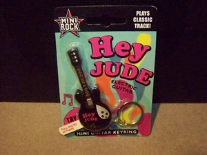 THE BEATLES MINI GUITAR RING PLAYS PART OF HEY JUDE SEALED - Picture 1 of 2
