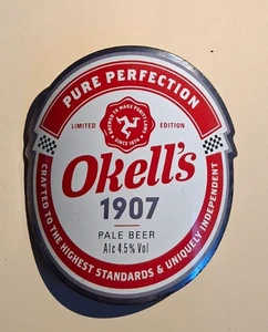 OKELL'S cervecería 1907 real ale bomba de cerveza clip insignia Isla de Man manx TT redondo - Imagen 1 de 1