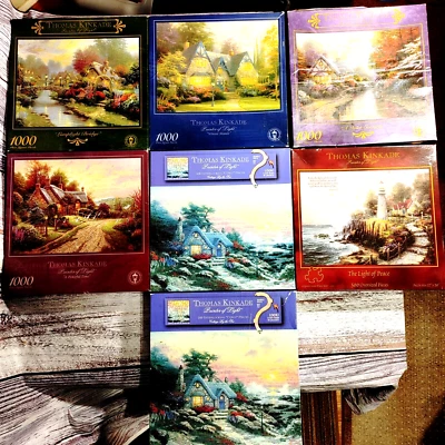 Thomas Kinkade Lot of 7 Puzzles. 4 X 1000 Pc + 3 X 500 Pc. All 12 X 12 X 2 boxes - Image 1 of 4