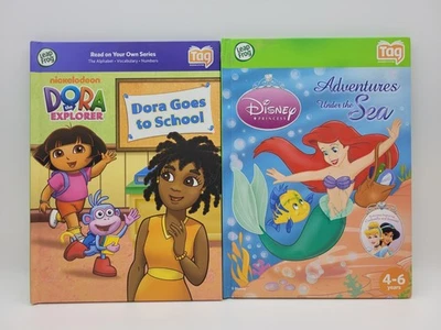 Lot/2 LeapFrog Tag Books Dora Disney Princess Ariel Cinderella LeapReader - Image 1 of 2