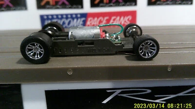 AFX RACING H.O. SCALE MEGA G+ 1.7 NARROW CHASSIS CHROME IN-LINE STYLE RED CAM - Image 1 of 4
