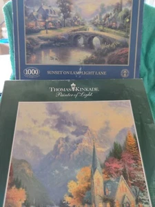 2 rompecabezas Thomas Kinkade, puesta de sol en el carril de la luz de la lámpara y la capilla de la montaña - Imagen 1 de 3