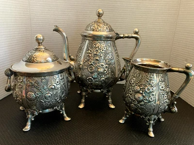 CONJUNTO DE CHÁ ANTIGO DE 3 PEÇAS DESIGN DE FLOR PERSEGUIDA À MÃO PLACA DE PRATA DA DÉCADA DE 1870 - Imagem 1 de 4