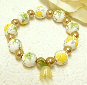 GLAS & KERAMIK GELB FLORAL CHARM PERLEN STRETCH ARMBAND - Bild 1 von 3