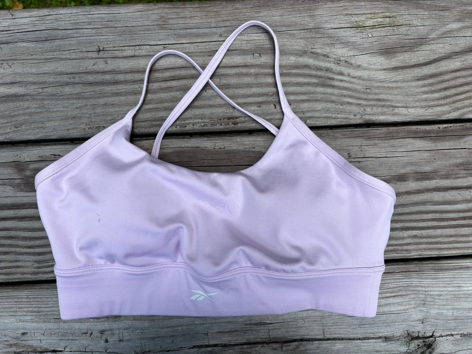 Sujetador deportivo para mujer Reebok rosa claro talla M almohadillas extraíbles elásticas Foto 1 de 4