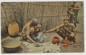 South Africa - Native Men Braying the Skin - 1900s Vintage Color Postcard - Picture 1 of 2