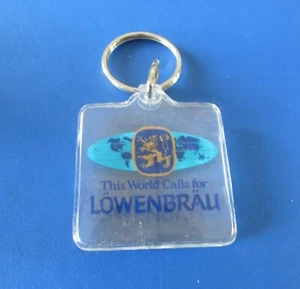 Rare Vintage WORLD CALLS FOR LOWENBRAU Keychain Plastic Key Chain  - Bild 1 von 4