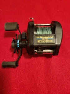 NICE ABU GARCIA AMBASSADEUR XLT 2 SYNCRO HIGH SPEED GRAPHITE GOOD CONDITION - Picture 1 of 5