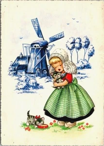 Gattino che tiene bambina olandese. Un Latte da bere e mulino a vento, blu Delft - Foto 1 di 2