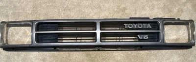 84-88 Toyota Pickup 4Runner Grille & Chrome Headlight Surrounds w/ V6 Emblem OEM - Image 1 of 4
