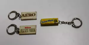 AÑOS 1970 BARRAS DE CHOCOLATE NOVEDAD LLAVEROS CAMISETA LECHE AERO DULCE MARIE HONG KONG - Imagen 1 de 2