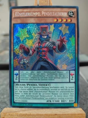 KÜNSTLERKUMPEL PENDELZAUBERER - BOSH-DE090 Secret Rare / 1. Auflage Near Mint  - Bild 1 von 3