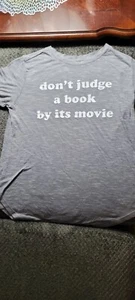Gently Used Graphic Sz S Modern Lux Gray Tee "Don't Judge A Book By It's Movie" - Picture 1 of 7