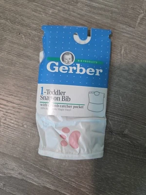 Babero de vinilo a presión Gerber vintage para niños pequeños con estampado de pata de bolsillo para atrapas de migas Foto 1 de 2