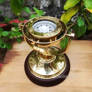 brass gimbal compass with a wooden base is a wonderful addition to any collectib - Picture 1 of 5