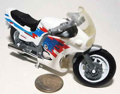 Small Plastic Motorcycle in White with Red and Blue Trim - Image 1 of 4
