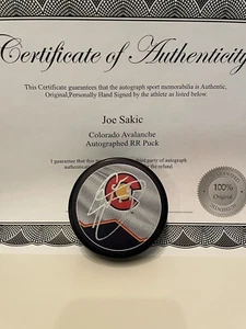 Joe Sakic Arturi Lehkonen Signed Autographed Puck Colorado Avalanche COA W/Case - Picture 1 of 2