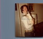 FOUND COLOR PHOTO J+4001 MAN HOLDING GLOWING EYED SIAMESE CAT