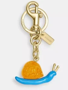 100% AUTHENTIC! COACH X OBSERVED BY US Orange SNAIL Gold Keychain Bag Charm NWT! - Picture 1 of 7
