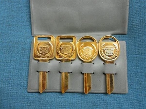 GM CADILLAC CREST GOLD C+D NOS KEY BLANKS WITH FACTORY LIGHT GRAY SLEEVE - Picture 1 of 3