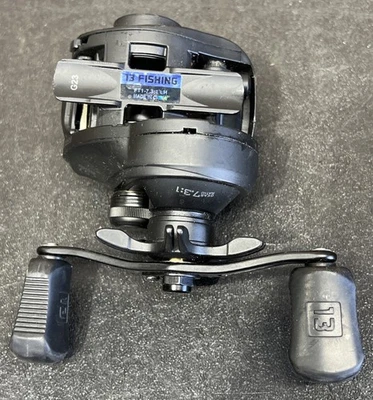 13 Fishing Origin FT1 Baitcasting Reel 7.3:1 Gear Ratio Left Hand Retrieve 5 Bea - Image 1 of 4