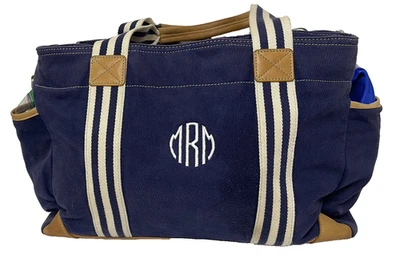 Bolso de viaje de lona azul marino y cuero marrón con ribete forrado usado Foto 1 de 4