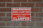 WHEEL CLAMP AREA UNAUTHORISED ILLEGALLY PARKED VEHICLES WILL BE CLAMPED sign car