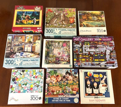 LOT - 9 300-PC JIGSAW PUZZLES-AMERICANA/CATS/MYSTICAL/SQUISHMALLOWS/WIZARD OF OZ - Image 1 of 4